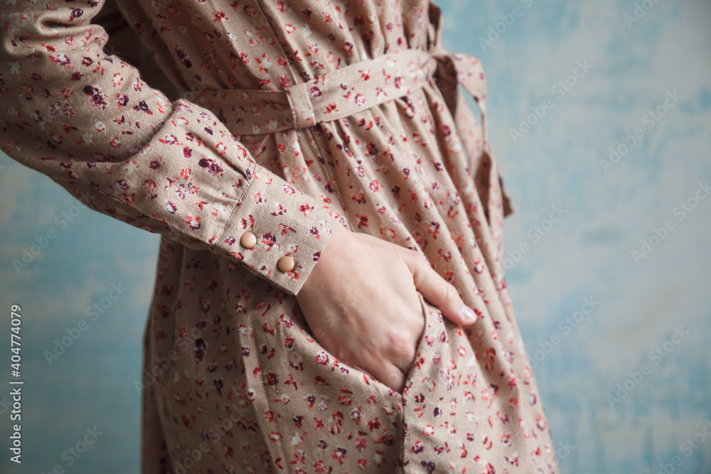 Girl in a beautiful vintage dress holds her hand in her pocket close-up