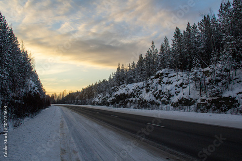 Wonderful winter track in Siberia between the rocks at dawn. Siberian track at dawn © Илья Юрукин