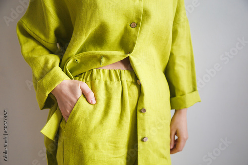 Girl in pajamas in a yellow shirt made of linen, beautiful home clothes. Cozy bathrobe. Natural fabric. Homewear