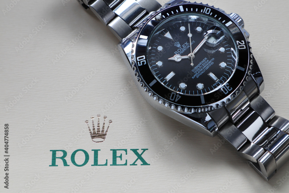 The Rolex vintage wristwatch ceramic bezel model black oyster perpetual  submariner date 39 mm display on the ivory background of Rolex crown logo  Stock Photo | Adobe Stock