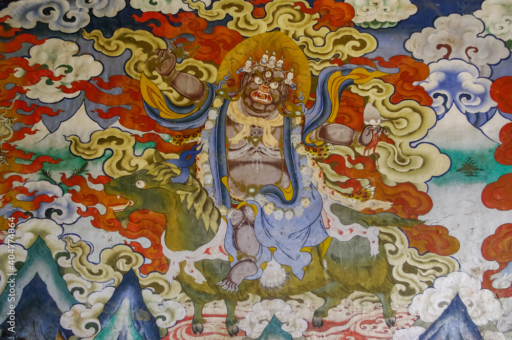 Colorful traditional wall painting of wrathful deity riding green horse in Gangtey gompa or monastery, Phobjikha valley, Bhutan