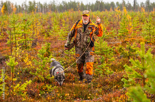 Hunter and his elkhound outdoor in the wilderness © RobertNyholm