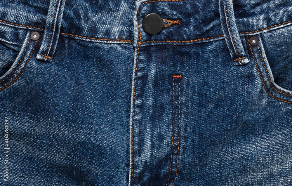 Waist area, zipper, and its button of dark blue jeans. Close up shot. Clothing concept Waist area, zipper, and its button of dark blue jeans. Close up shot. Clothing concept