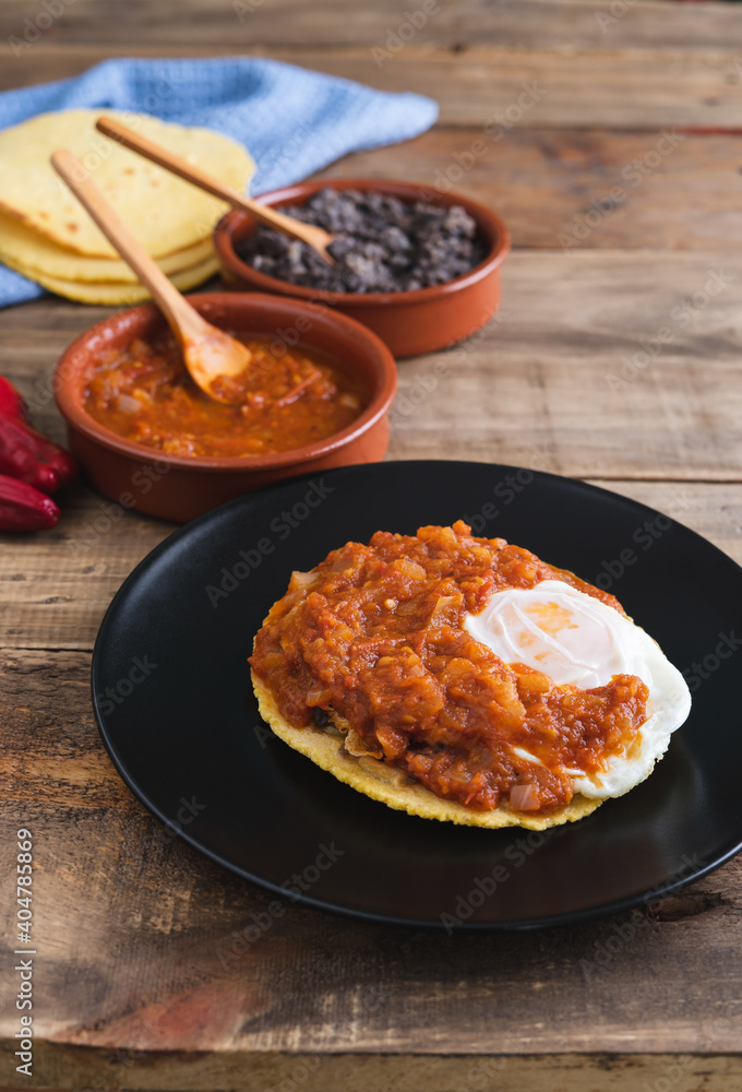 Huevos rancheros Mexican breakfast on a wooden base. Mexican cuisine. Copy space. Huevos rancheros Mexican breakfast on a wooden base. Mexican cuisine. Copy space.