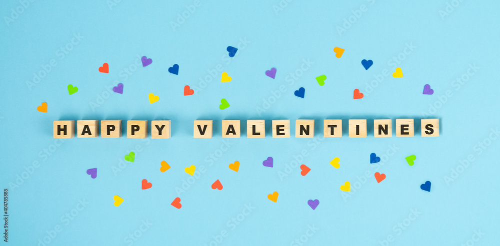 Valentine's Day. HAPPY VALENTINES letters on wooden cubes in a blue background. Copy space.