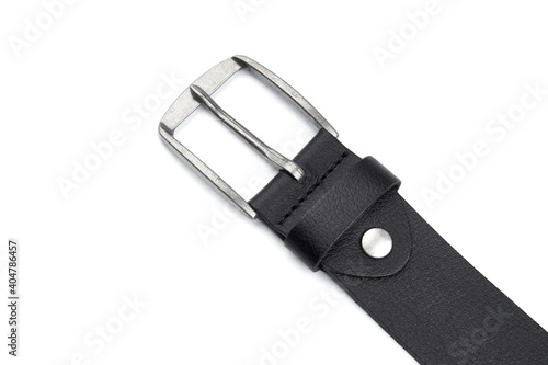 Fastened fashionable men s leather belt with dark matted metal buckle isolated on white background. Black belt for men. Black leather belt for trousers and jeans. Male accessory.
