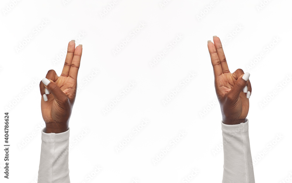 gesture and people concept - hands of african american woman showing two fingers or greeting on white background