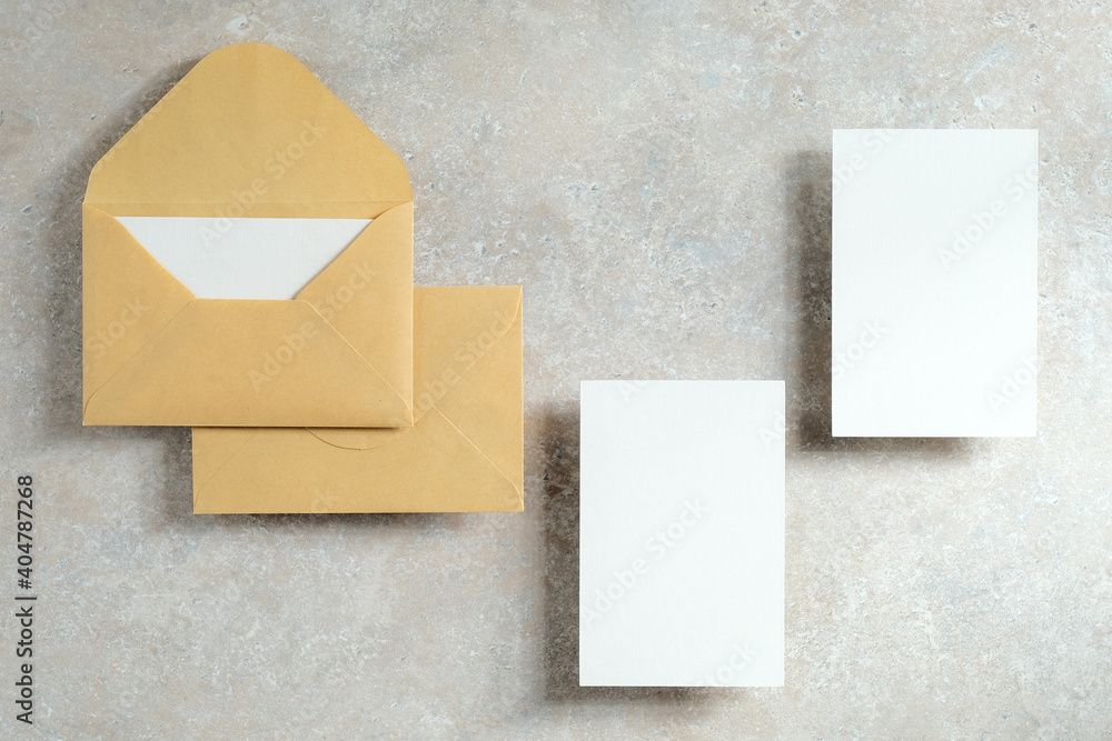 Wedding stationery template. Top view kraft paper envelopes and blank paper card on stone tabletop. Minimal style. Flat lay. Wedding stationery template. Top view kraft paper envelopes and blank paper card on stone tabletop. Minimal style. Flat lay.