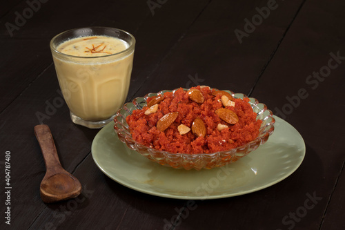 Indian Special Famous Winter Sweet Food Carrot Halwa or Gajar ka Halwa Served With Kesar Masala Milk  photo