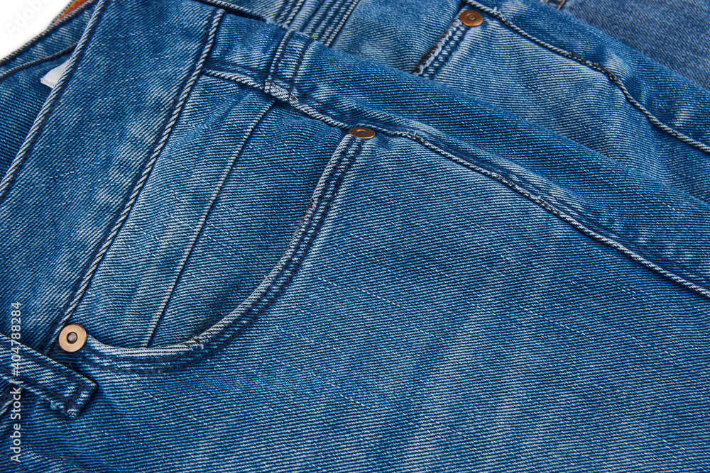 Stack of Various Shades Of Blue Jeans On White Background Denim jeans texture. Denim background texture for design. Canvas denim texture. Blue denim that can be used as background. Stack of Various Shades Of Blue Jeans On White Background Denim jeans texture. Denim background texture for design. Canvas denim texture. Blue denim that can be used as background.