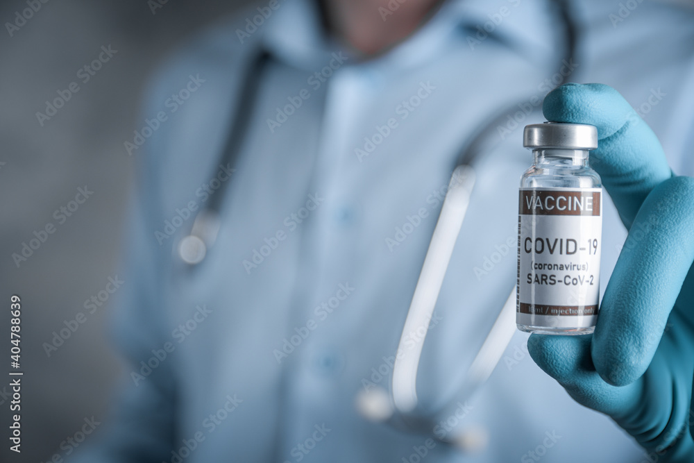 Doctor with a stethoscope on shoulder holding in hand COVID-19 , coronavirus, SARS-cov-2 vaccine. Healthcare And Medical concept.Development and creation vaccine Doctor with a stethoscope on shoulder holding in hand COVID-19 , coronavirus, SARS-cov-2 vaccine. Healthcare And Medical concept.Development and creation vaccine