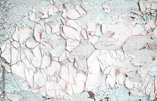 Old grungy cracked white and blue grey weathered wall paint peeling off rusted metal sheet. Textured background for posters and bloggers