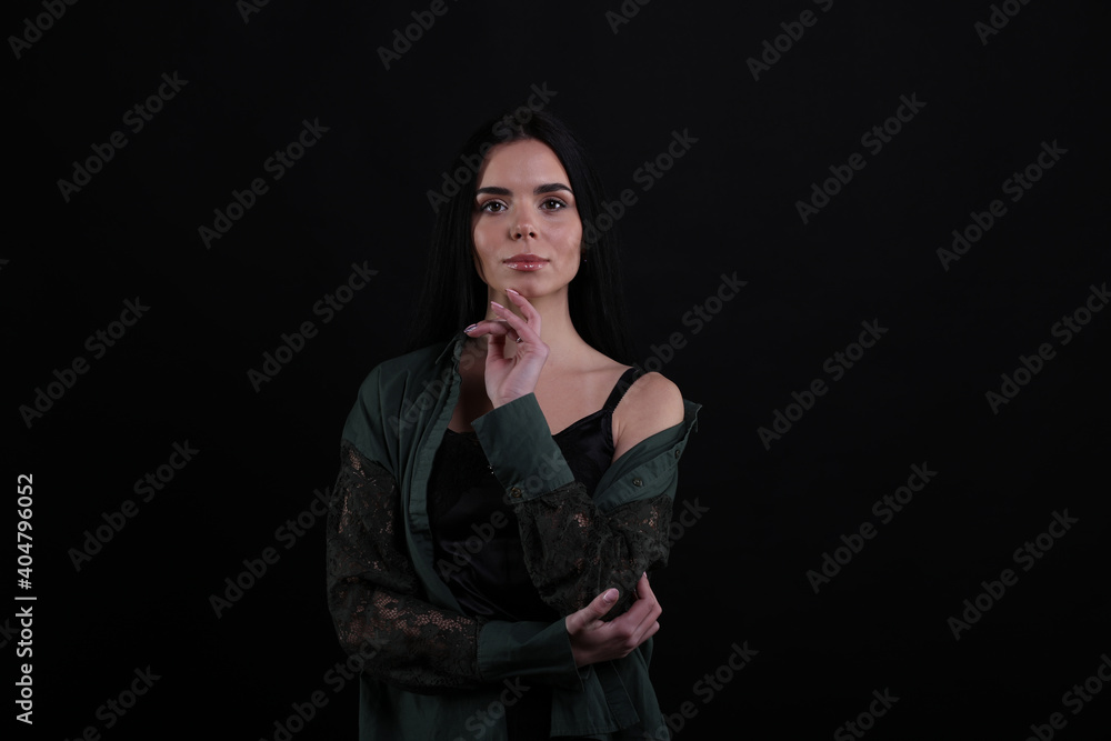 Portrait of beautiful young brunette woman on black background Portrait of beautiful young brunette woman on black background