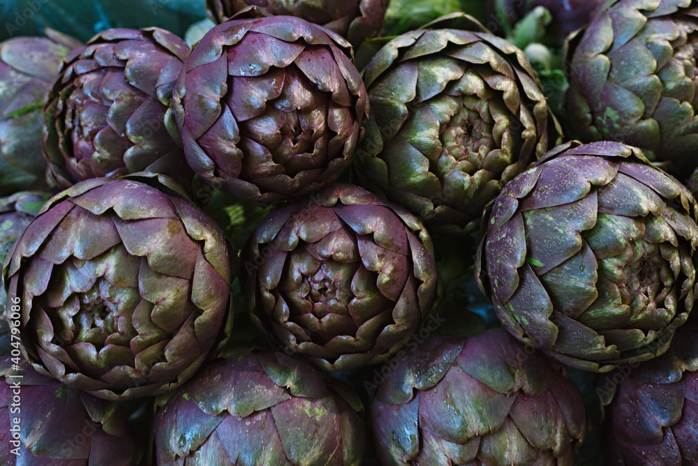 Violet artichoke flower plant. Close-up on sale in a vegetable shop Violet artichoke flower plant. Close-up on sale in a vegetable shop