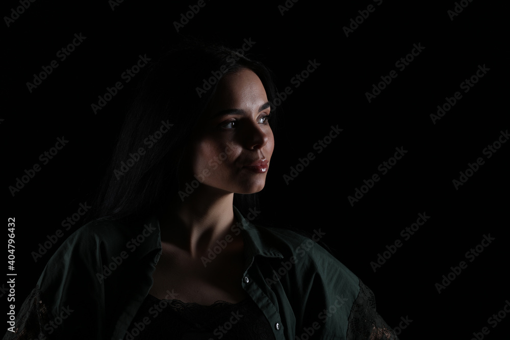 Portrait of beautiful young brunette woman on black background Portrait of beautiful young brunette woman on black background