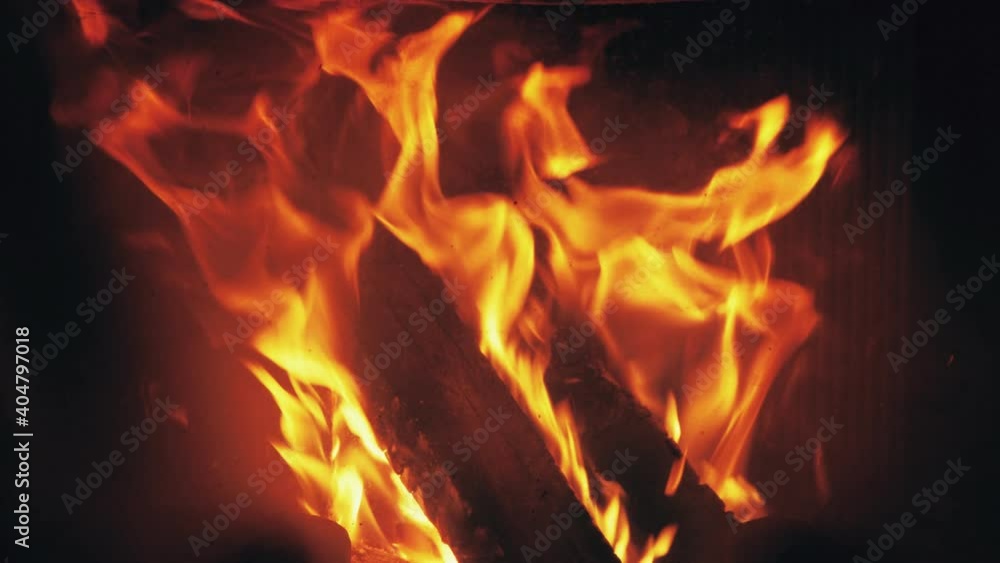 Fire is burning in home fireplace background. Hot flames bonfire in rural house Fire is burning in home fireplace background. Hot flames bonfire in rural house