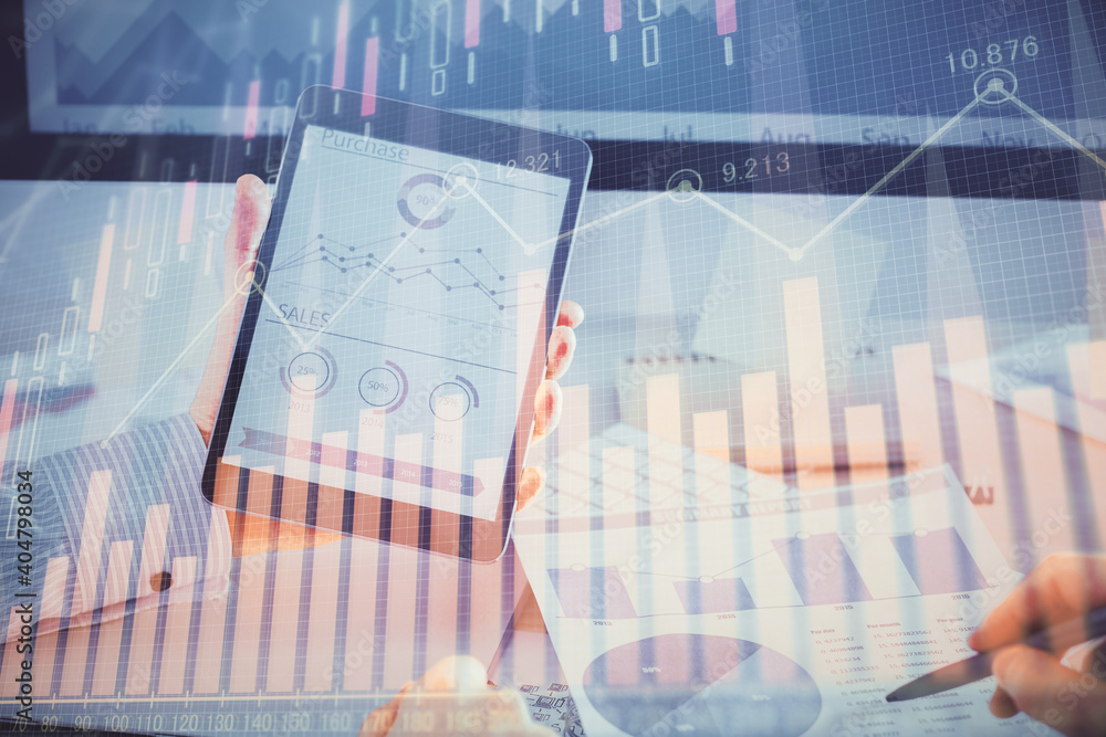 Double exposure of man's hands holding and using a digital device and forex graph drawing. Financial market concept. Double exposure of man's hands holding and using a digital device and forex graph drawing. Financial market concept.