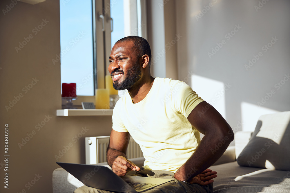 Wall Mural Afro-American male is squinting from the sun