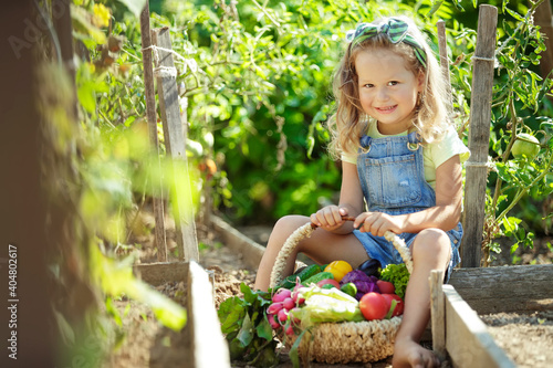 Child and vegetables. Selective focus. Little girl in nature with the right food. High quality photo.