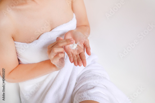 Woman applying cream,lotion on hand with white background, Beauty concept, Top view.