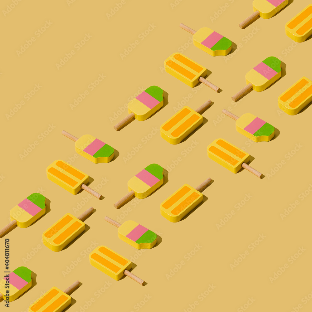 Colorful sunlit popsicles pattern on a pale yellow background. Minimal summer layout. Colorful sunlit popsicles pattern on a pale yellow background. Minimal summer layout.
