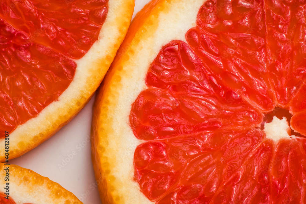 Macro Round Fresh Juicy Sliced Slices Of Red Citrus Orange. Pieces of Grapefruit Fruit Isolated, Close-up. The Concept Of Healthy Eating. Macro Round Fresh Juicy Sliced Slices Of Red Citrus Orange. Pieces of Grapefruit Fruit Isolated, Close-up. The Concept Of Healthy Eating.