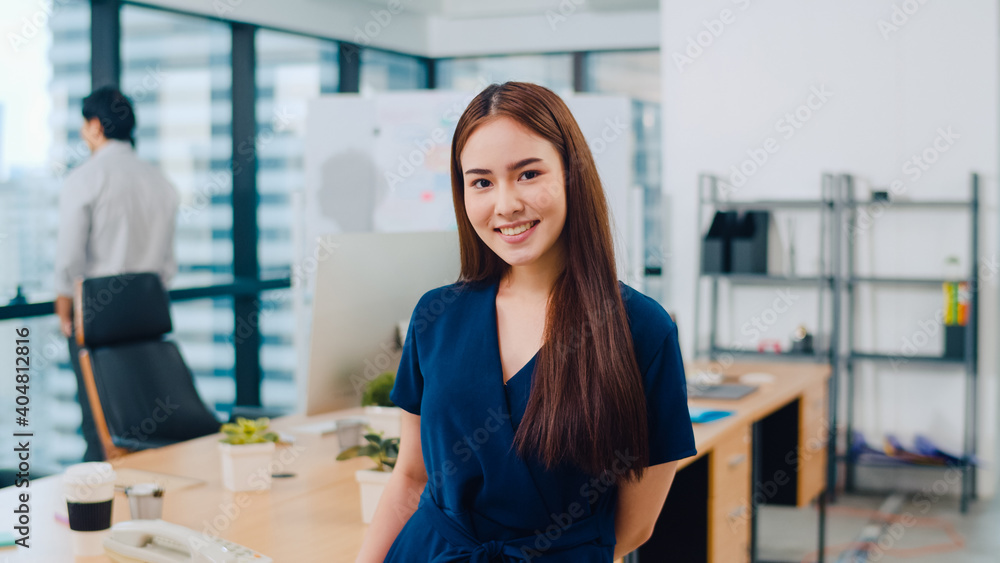 Portrait of successful beautiful executive businesswoman smart casual wear looking at camera and smiling, happy in modern office workplace. Young Asia lady standing relax in contemporary meeting room. Portrait of successful beautiful executive businesswoman smart casual wear looking at camera and smiling, happy in modern office workplace. Young Asia lady standing relax in contemporary meeting room.