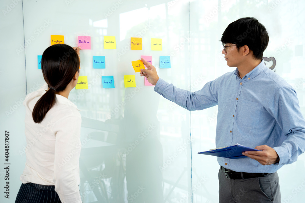 Businessmen and woman are standing He giving advice and brainstorming Businessmen and woman are standing He giving advice and brainstorming