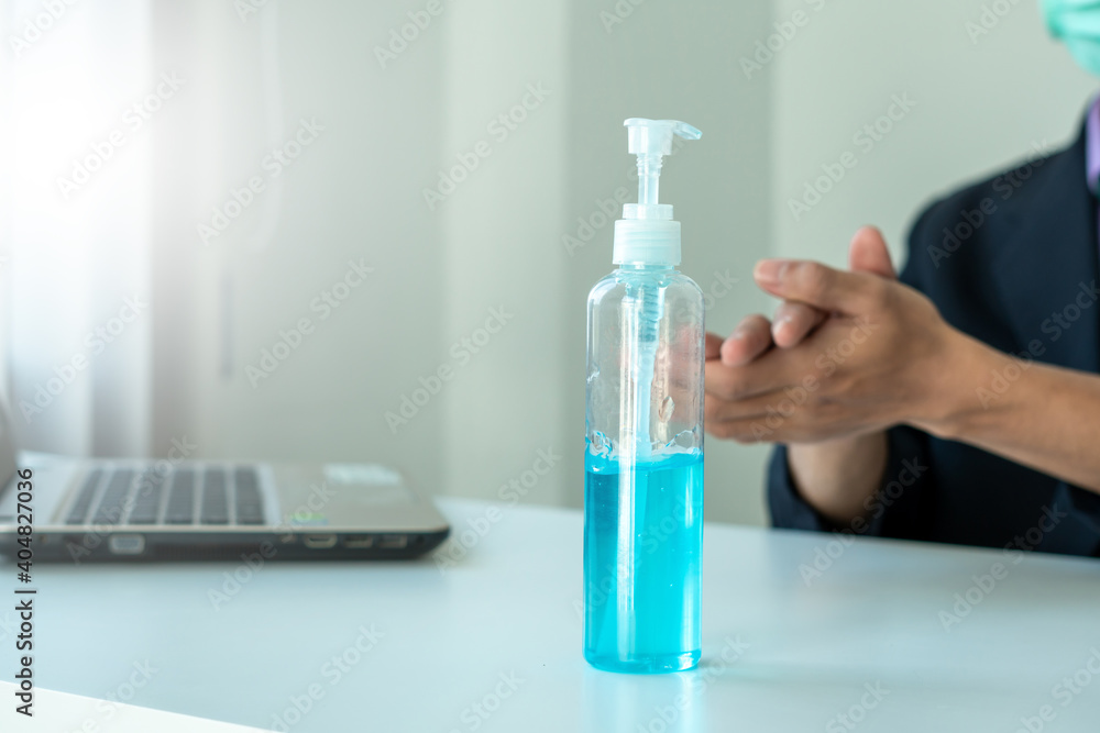 Man hands using wash hand alcohol gel or sanitizer bottle dispenser, against Novel coronavirus or Coronavirus Disease (Covid-19) . Man hands using wash hand alcohol gel or sanitizer bottle dispenser, against Novel coronavirus or Coronavirus Disease (Covid-19) .