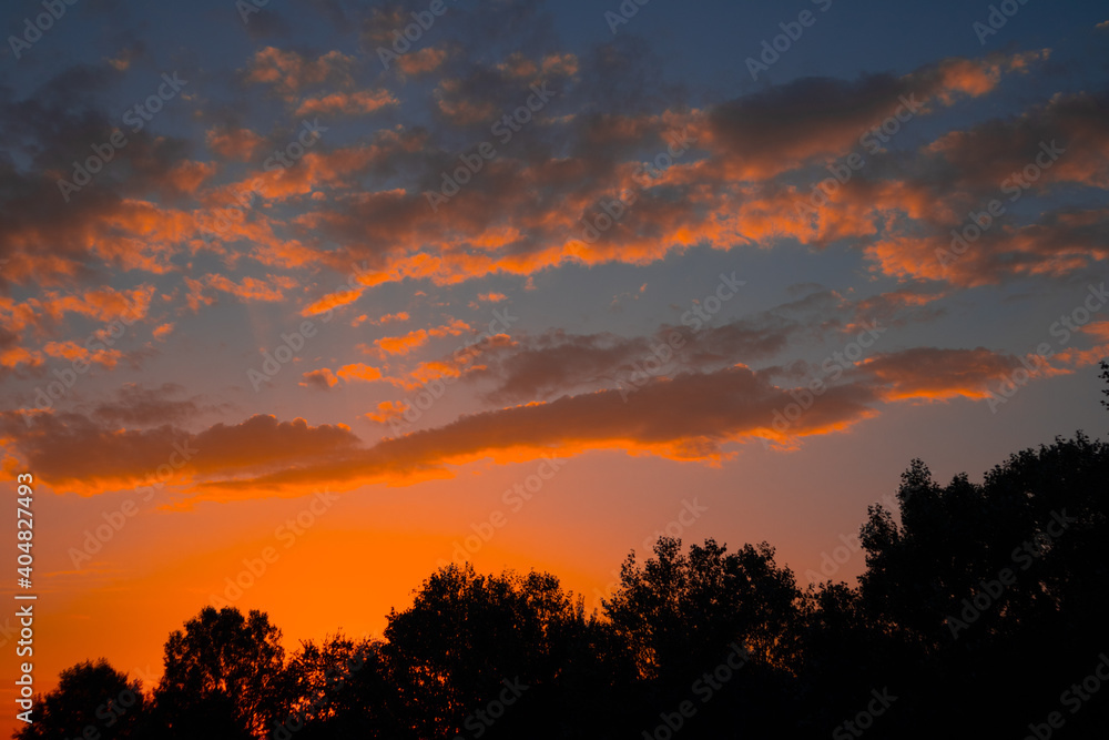 Orange cloudy sunset at the city