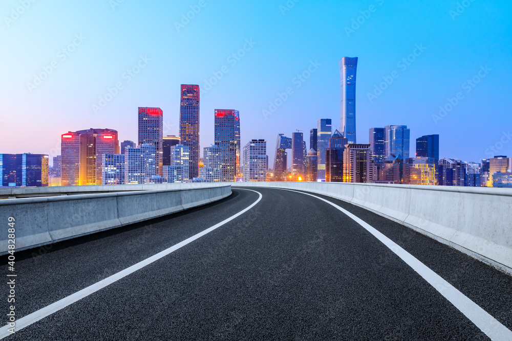 Asphalt road and modern city commercial buildings in Beijing at night,China.