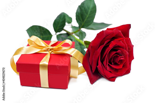 Red rose and red gift box on white background