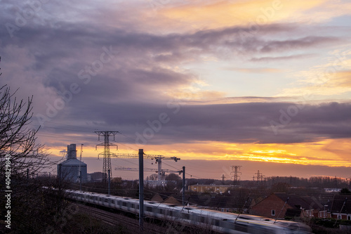 Sun setting over an industrial landscape © John