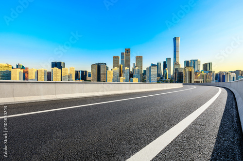 Asphalt road and modern city commercial buildings in Beijing at sunrise China.