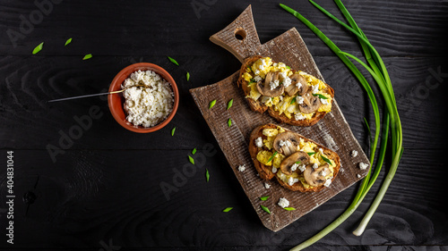 wholewheat toast with scrambled eggs with mushrooms and cottage cheese. healthy breakfast or brunch. banner, menu recipe place for text, top view