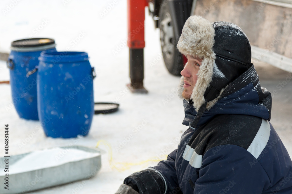Portrait of a fitter in a blue jacket at a construction site Portrait of a fitter in a blue jacket at a construction site