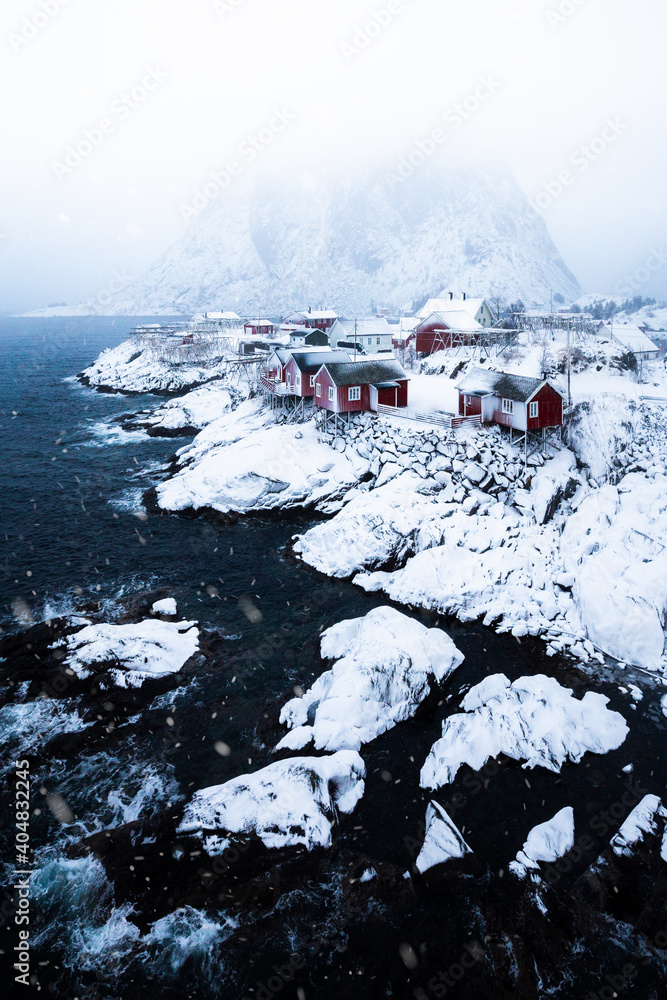 Lofoten Islands winter scenery with fisherman cabins during a snowstorm, Norway, Scandinavia