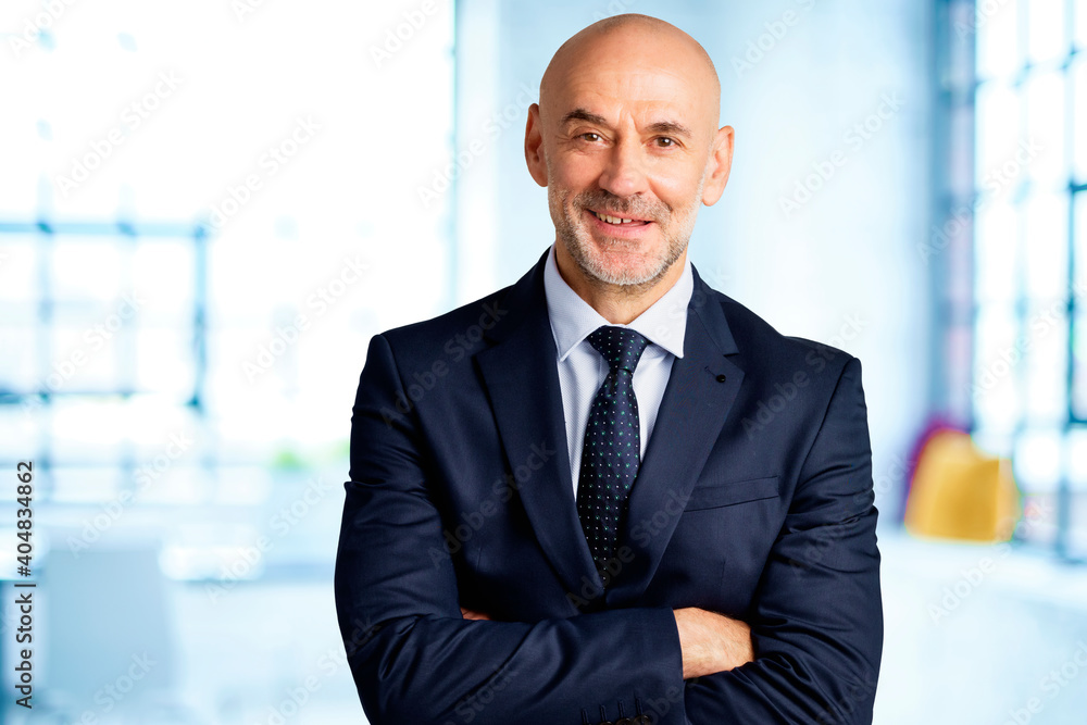 Professional businessman wearing suit while standing at the office Professional businessman wearing suit while standing at the office