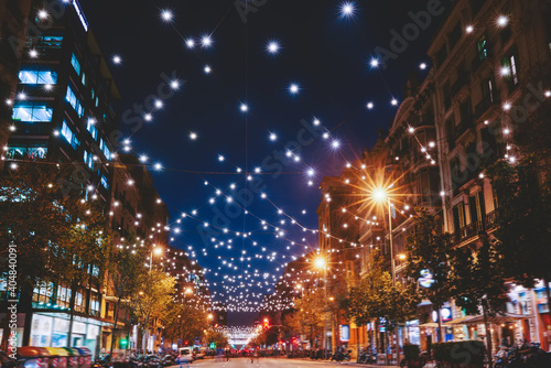 Illuminated modern city street with shiny garlands