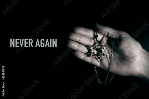 star of david in a pendant and text never again photo