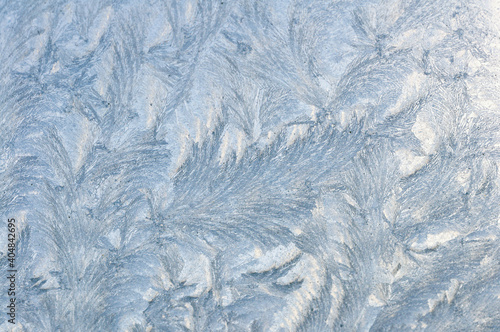 Frost design on a window in winter. Ice design, nature abstract, december texture and pattern