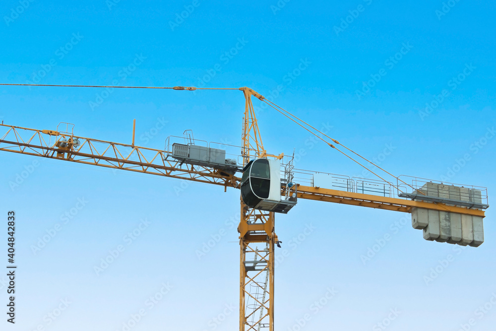 Construction crane on the isolated background of the sky