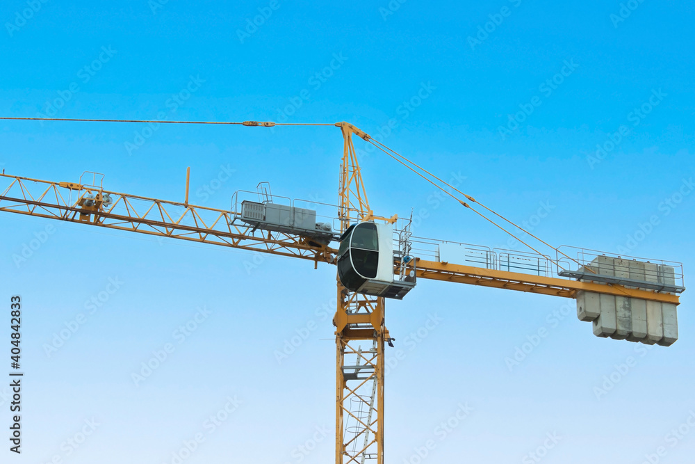 Construction crane on the isolated background of the sky Construction crane on the isolated background of the sky