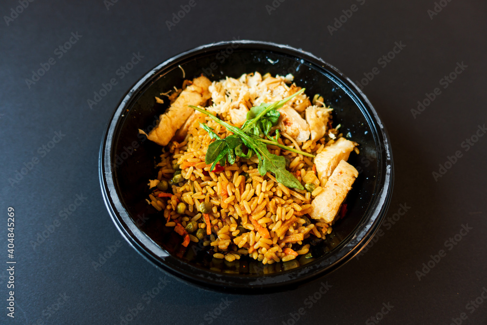 Wok rice cooked with soy sauce, vegetables and chicken pieces. Wok rice cooked with soy sauce, vegetables and chicken pieces.
