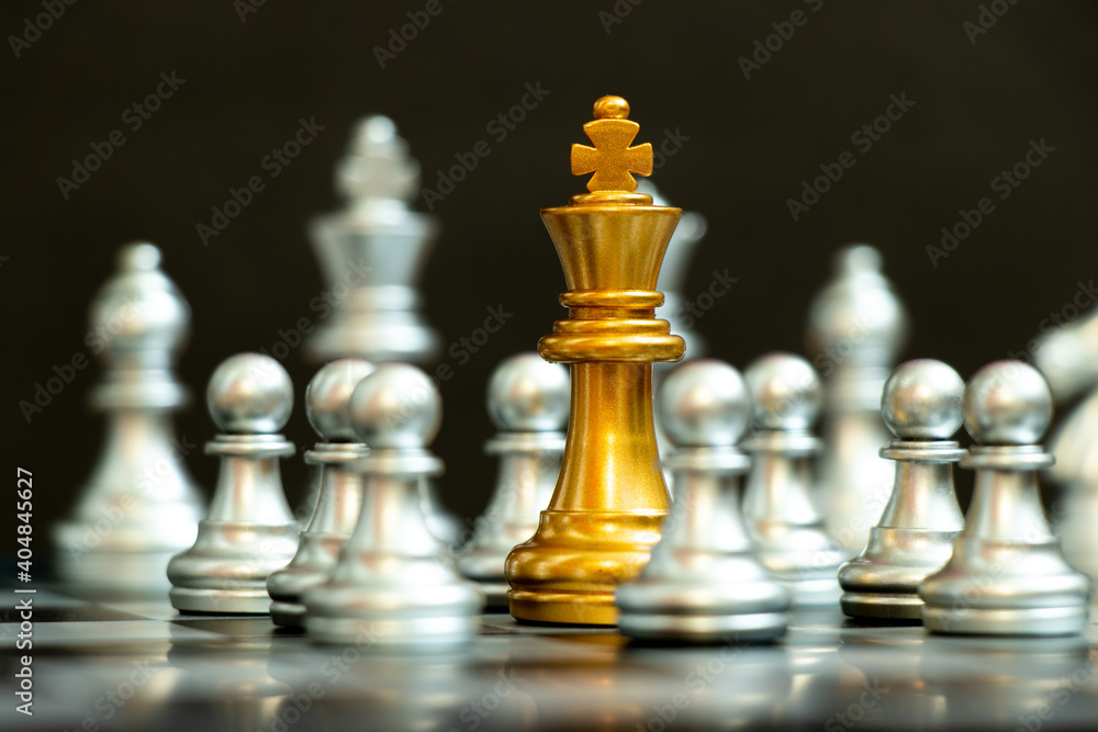 Gold king in chess game surrond with the another silver team on black background (Concept for company strategy, business crisis or decision) Gold king in chess game surrond with the another silver team on black background (Concept for company strategy, business crisis or decision)