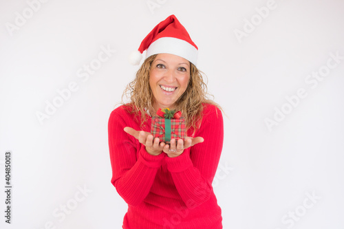 Amazed woman in santa hat lifting Christmas gift isolated on white background