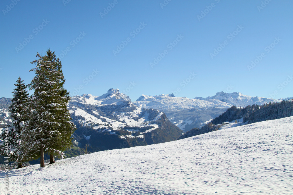 Autumn mountain panorama with fresh snow at Swiss village of Stoos.