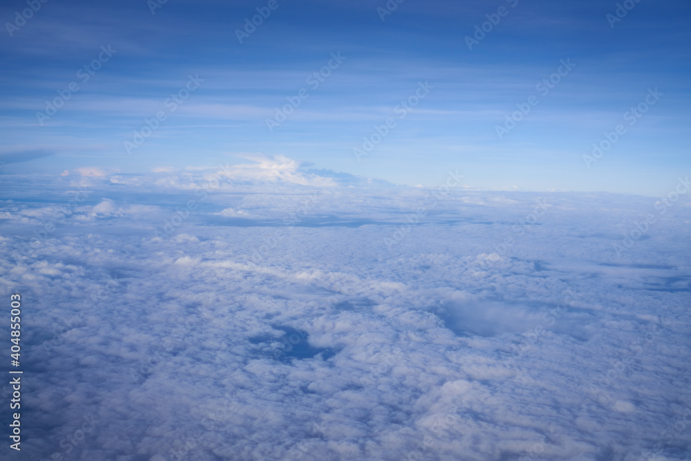 Cloud pattern with blue sky from airplane window