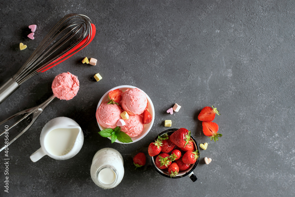 Strawberry ice cream and ingredients for cooking on a black background. Strawberry ice cream and ingredients for cooking on a black background.