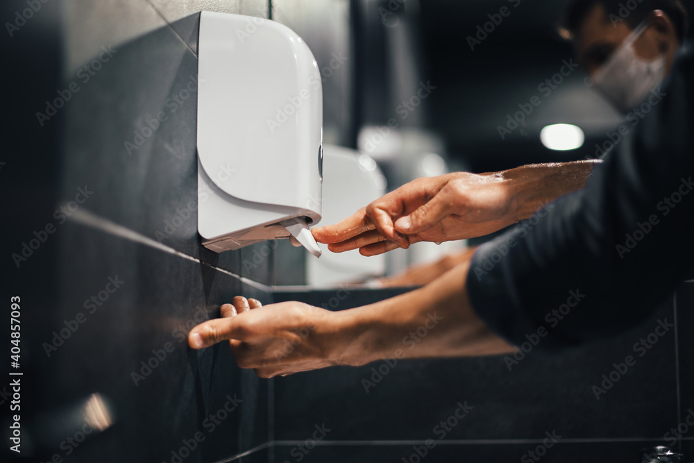 top view. a man carefully washes his hands in the bathroom
